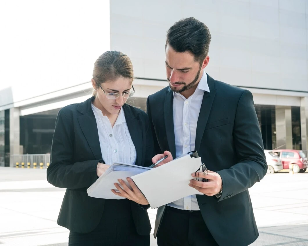 Managers reviewing property report documents